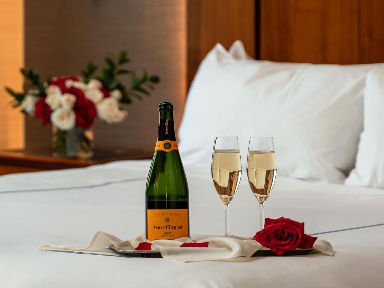 Champagne glasses on a bed