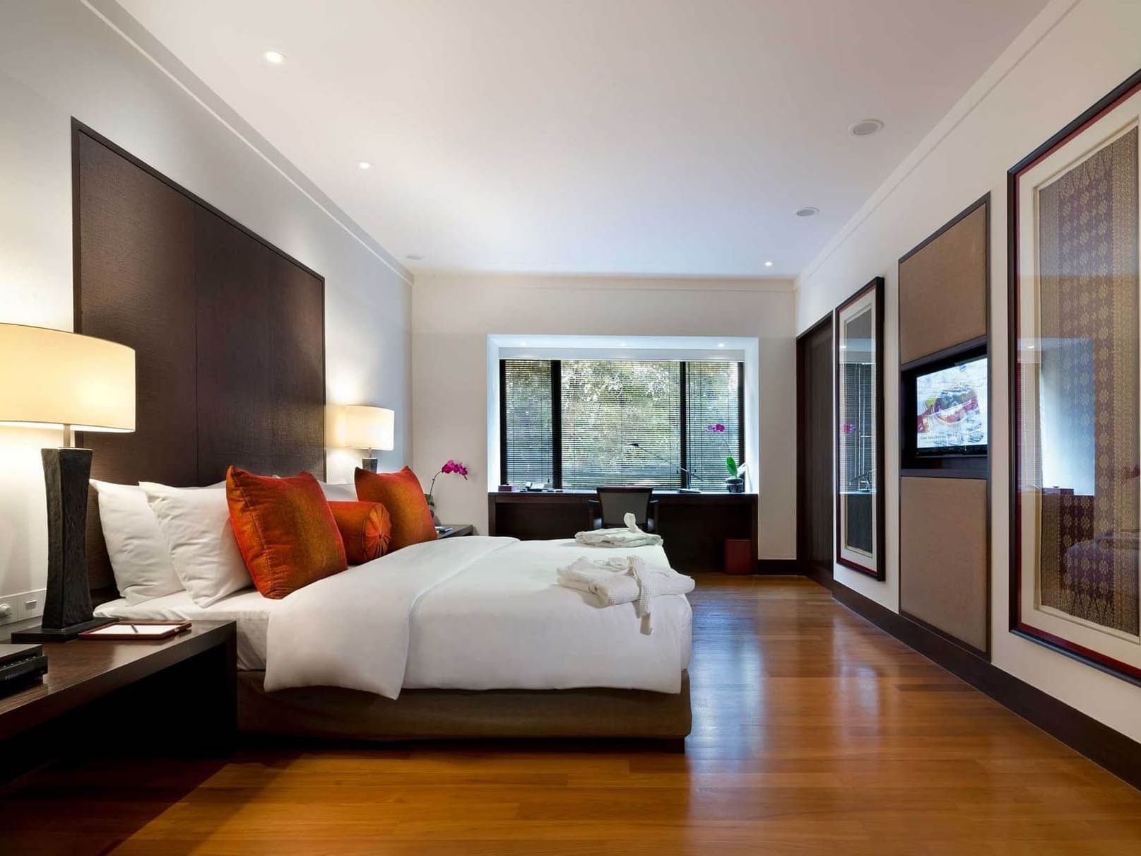 Spacious Executive Suite at The Saujana Hotel Kuala Lumpur with plush bed, wooden floors, and desk by the window