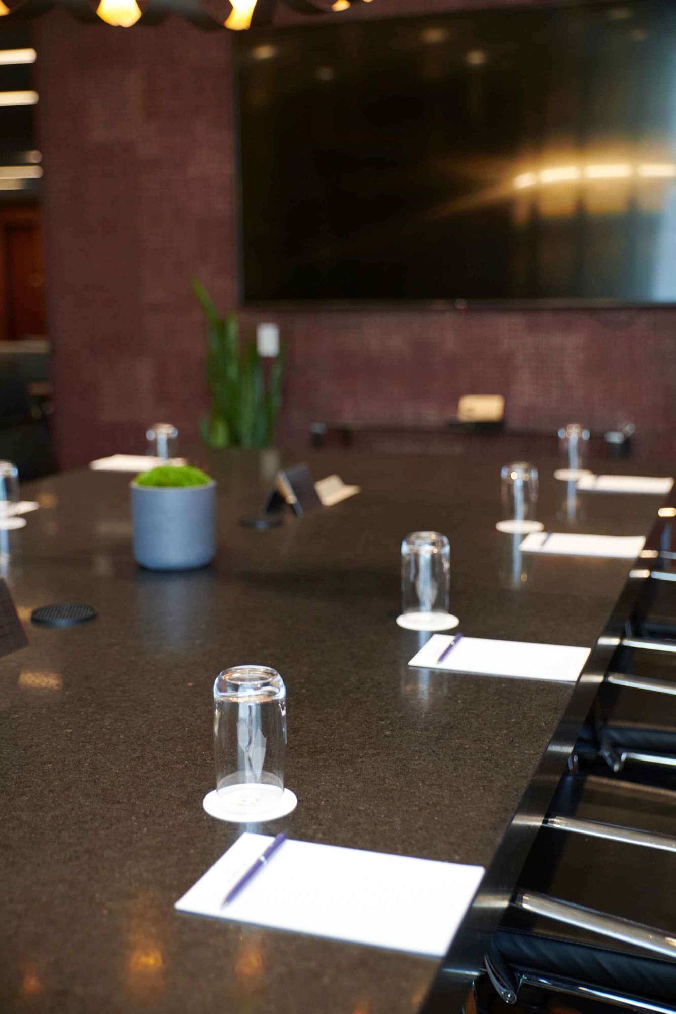 Professional boardroom table with glasses and notepads in Salon Du Président at Warwick Hotels and Resorts