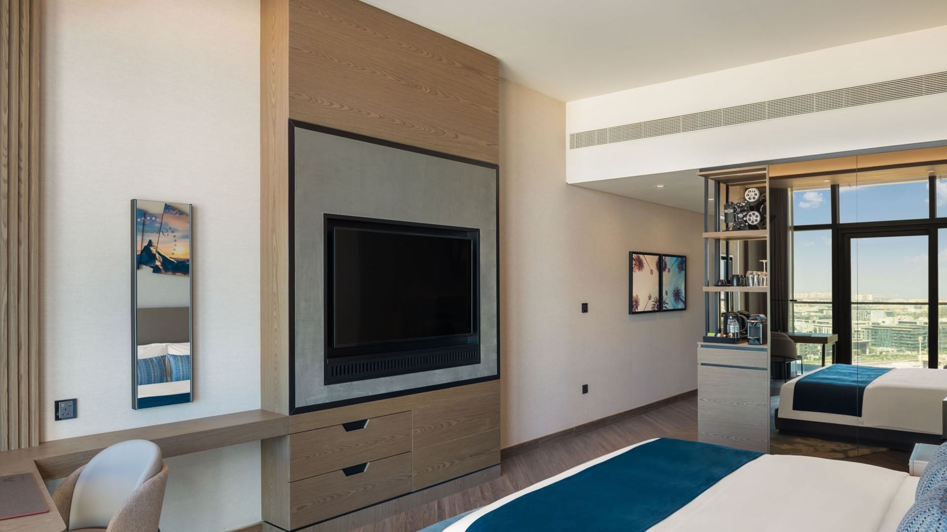 Workspace and cozy seating area facing the bed in Scene Room with a city view at Paramount Hotel Midtown