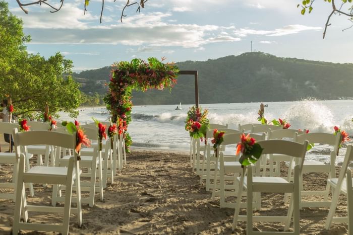 Wedding ceremony by the Beach at Villas Sol Beach Resort
