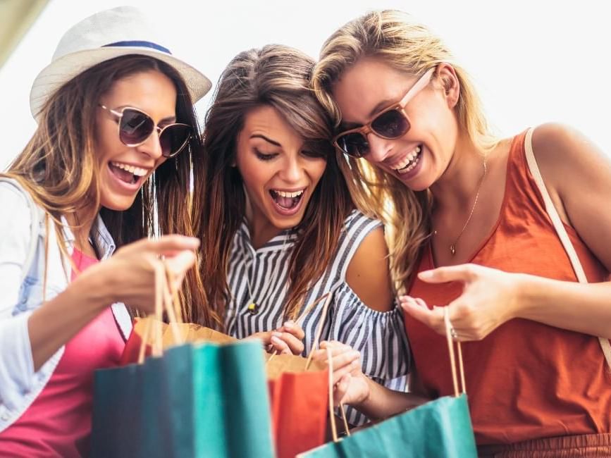Women looking inside shopping bags