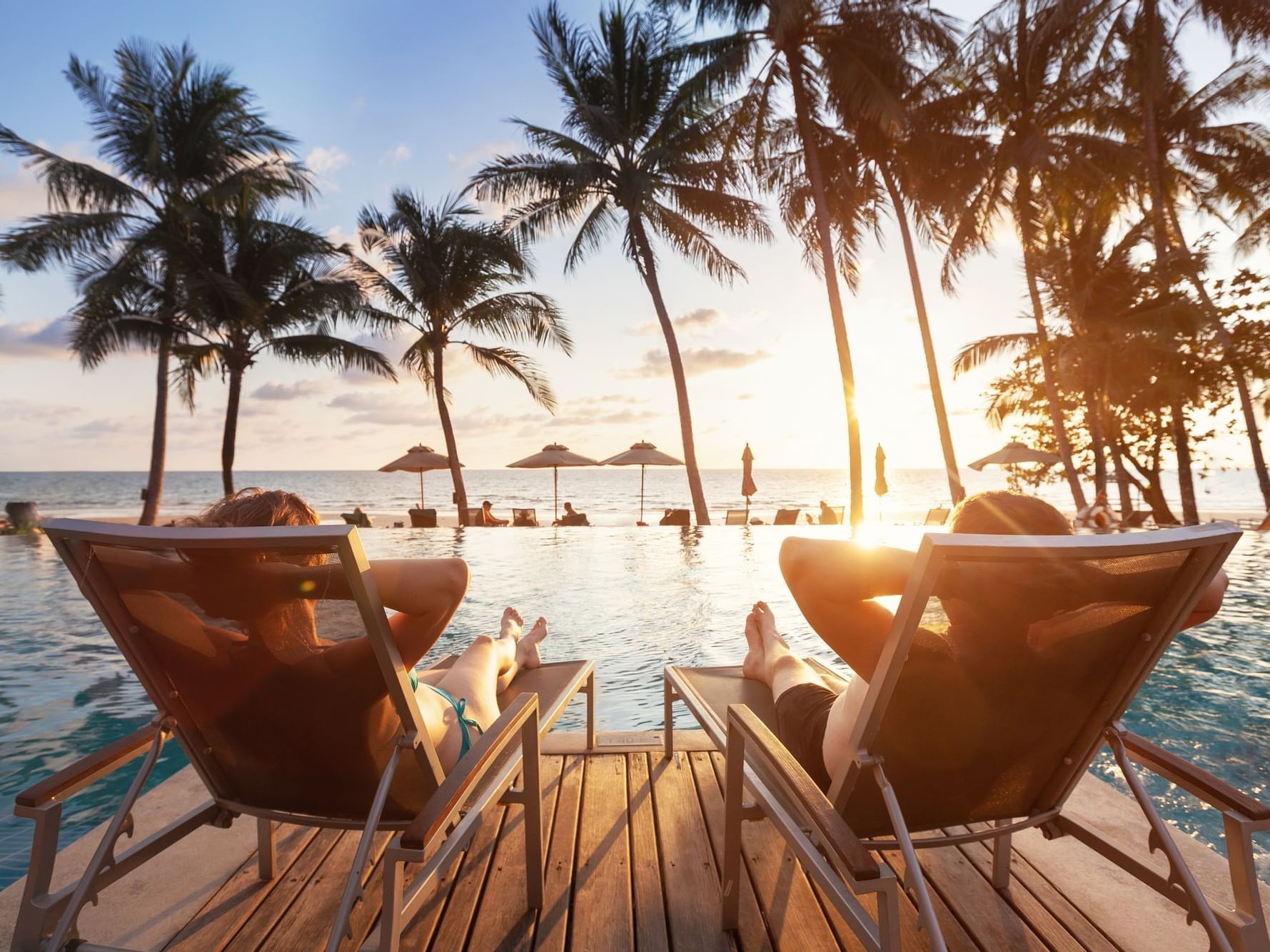 Couple relaxing by the pool at Daydream Island Resort