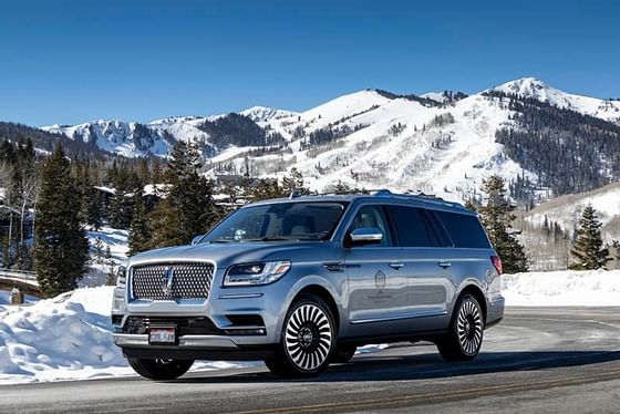 A Lincoln Navigator driving on a street near Stein Eriksen