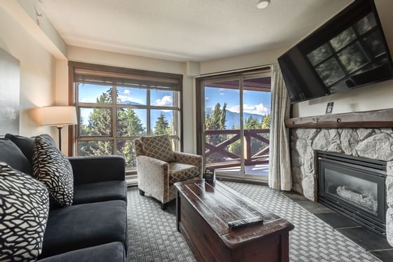Fireplace by TV lounge area in 1 Bedroom Mountainview Suite at Blackcomb Springs Suites