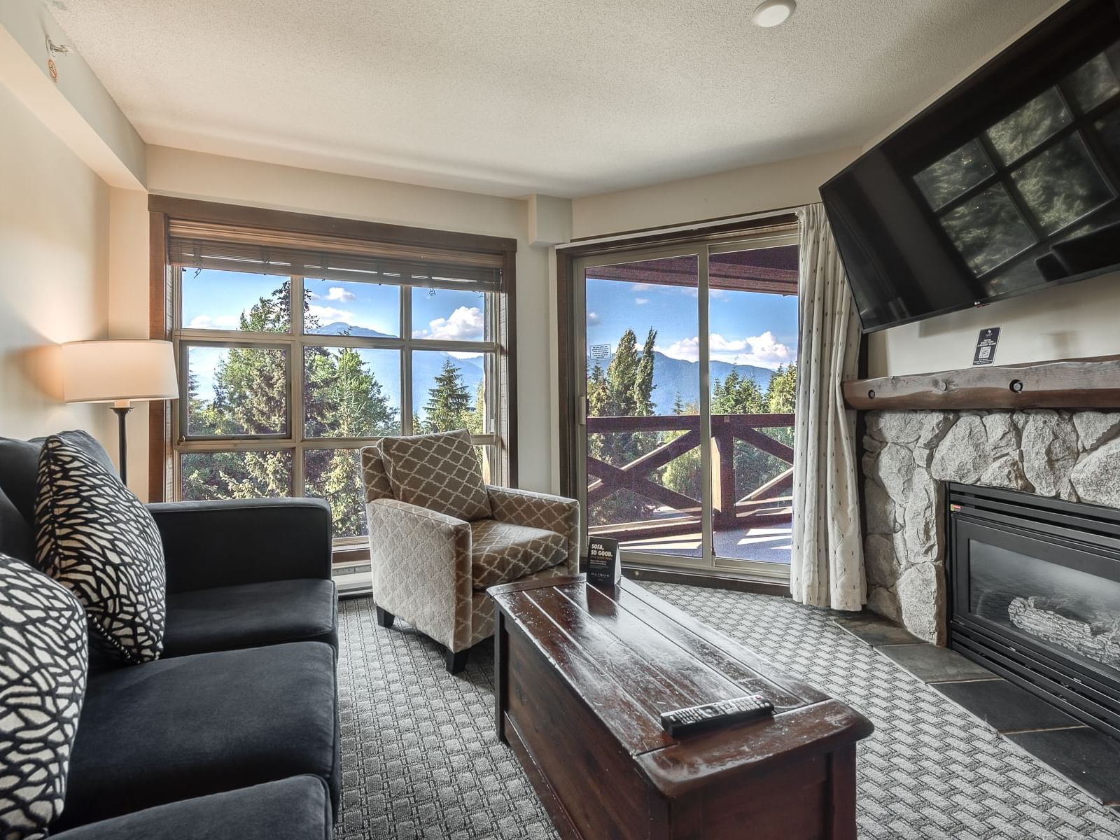 Fireplace by TV lounge area in 1 Bedroom Mountainview Suite at Blackcomb Springs Suites