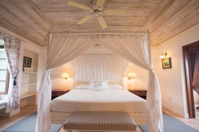 King-size canopy bed with ocean view