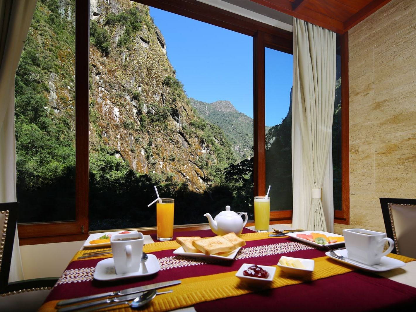 Breakfast table arranged with the mountain view at Hotel Sumaq