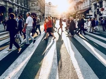 People walking on busy city street near Oliver Like Home