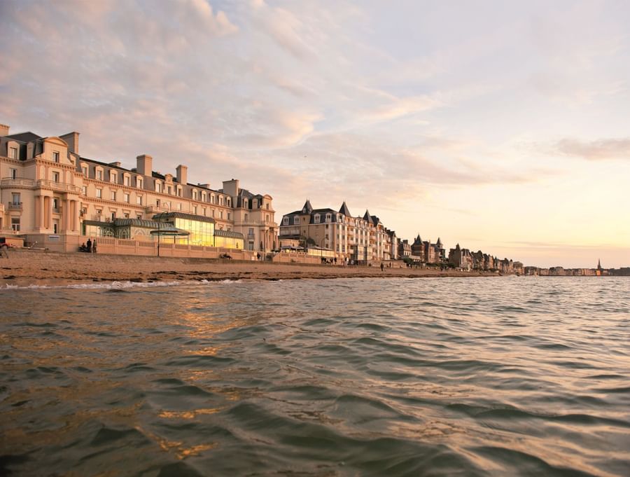 Grand beachfront hotels overlooking a calm ocean at Le Grand Hôtel des Thermes
