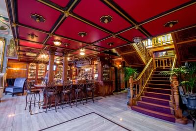 Interior of a Bar area with a stairway at Horton Grand Hotel