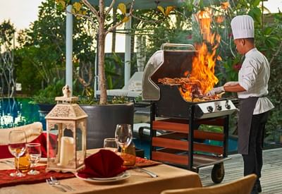 Chef using an outdoor BBQ grill at The Danna Langkawi