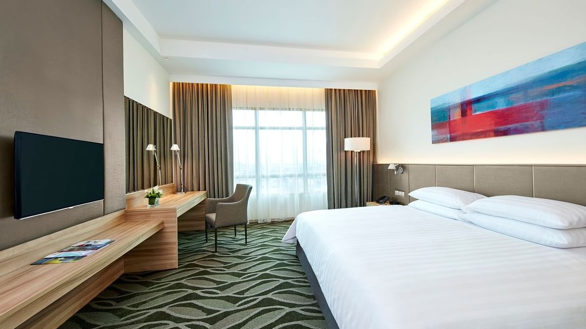A bed & a work desk in Deluxe Plus King Room at Sunway Lagoon