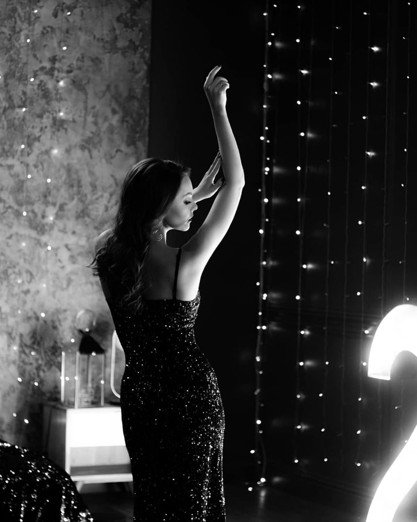 Lady dancing in a black dress at Honeyrose Hotel