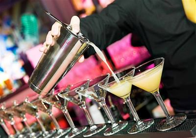 A bartender making cocktails in Sand Bar at Accra Beach Hotel & Spa