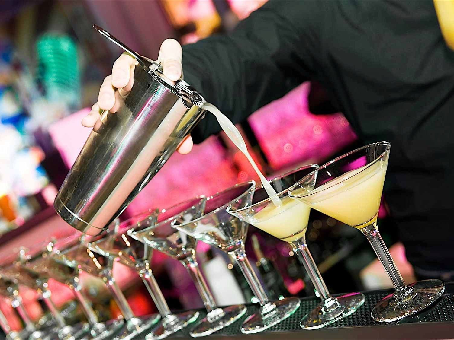 A bartender making cocktails at Sand Bar at Accra Hotels