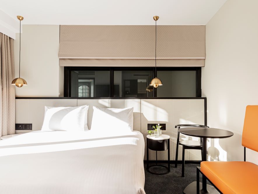 Bedroom with reading table in Balcony Room at Brady Hotels Jones Lane