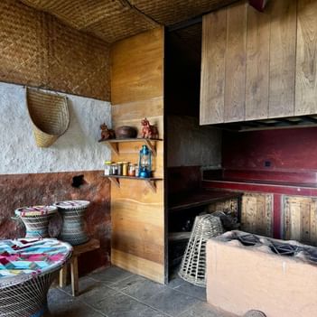 Traditional kitchen interior with woven decorations, wooden shelves, and baskets at The Terraces Resort & Spa