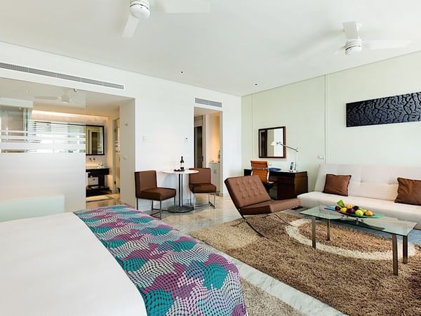 Bed and living area in Junior Suite King Size Bed Resort View at Mundo Imperial