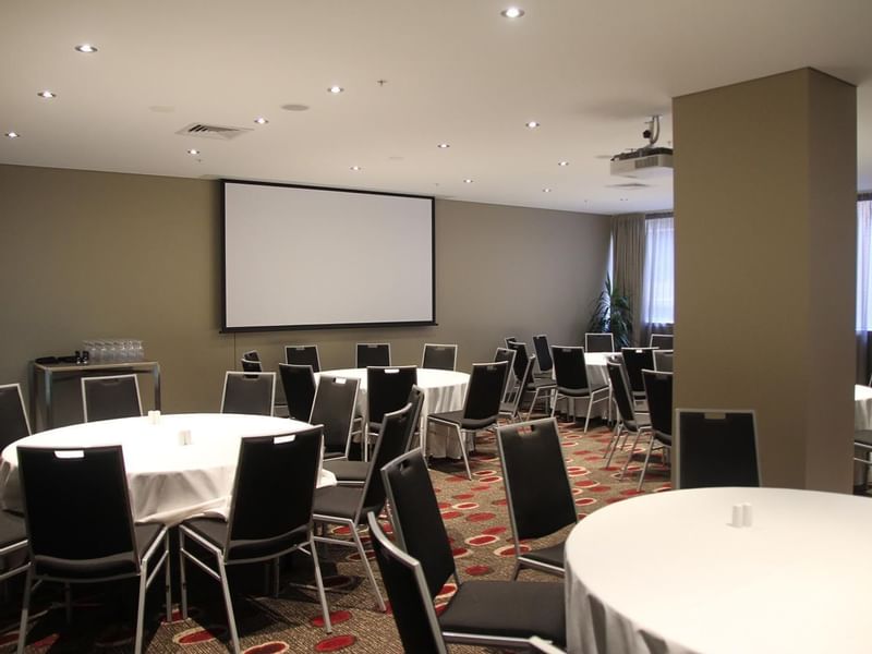 Banquet table set-up in Albert Room with carpeted floors at Pullman Albert Park