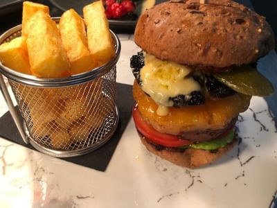 Close-up of a Juicy vegan burger & fries at Orsett Hall Hotel