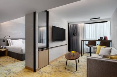 Interior of Deluxe Suite Livingroom area with a TV at Park Hotel Hong Kong