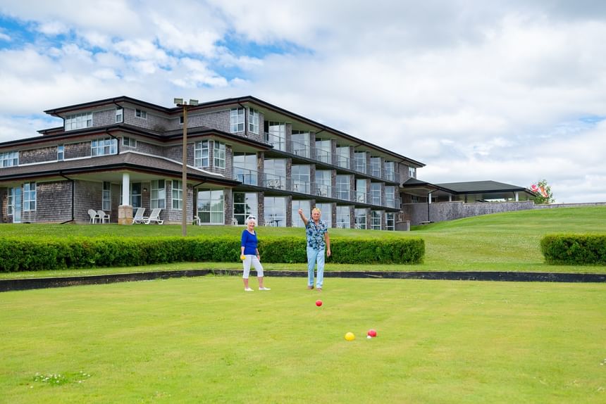 Couples playing bocce ball on a green lawn at Rodd Brudenell River Resort, one of the best accommodations in PEI