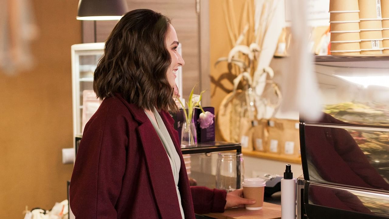 Women buying coffee at cozy coffeeplace