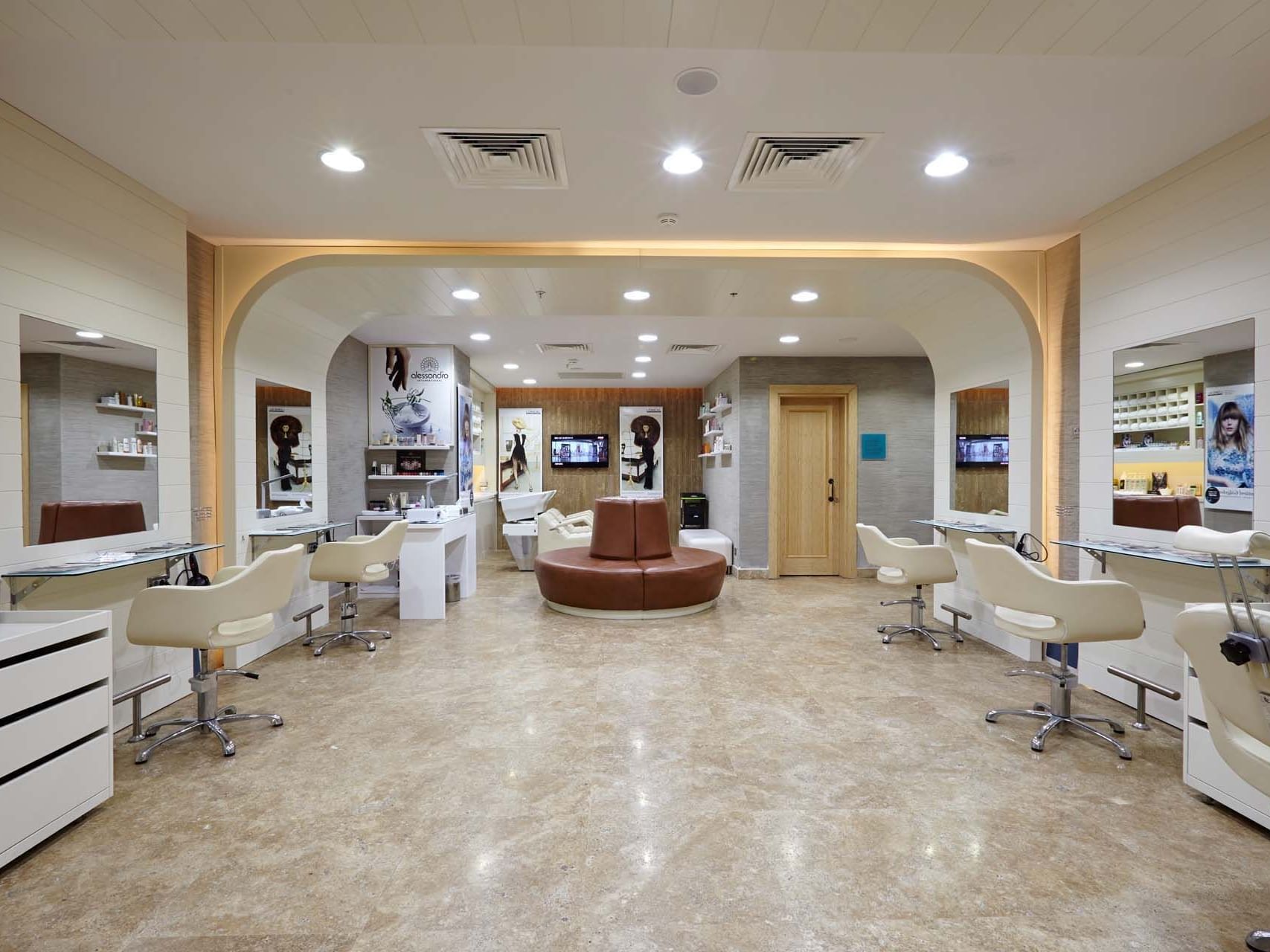 Modern hair salon interior with styling chairs and mirrors at Titanic Deluxe Golf Belek