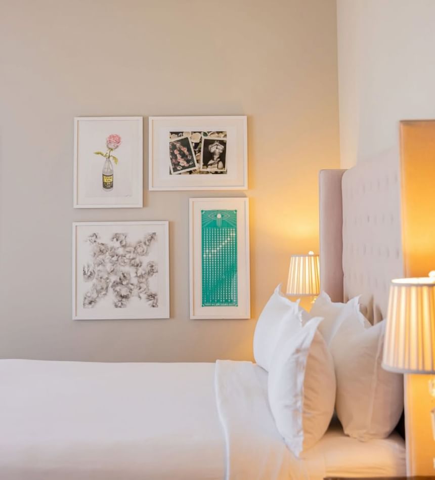 Bedside table lamps and curated art pieces above the bed in Classic Terrace Double at The Plymouth Hotel South Beach