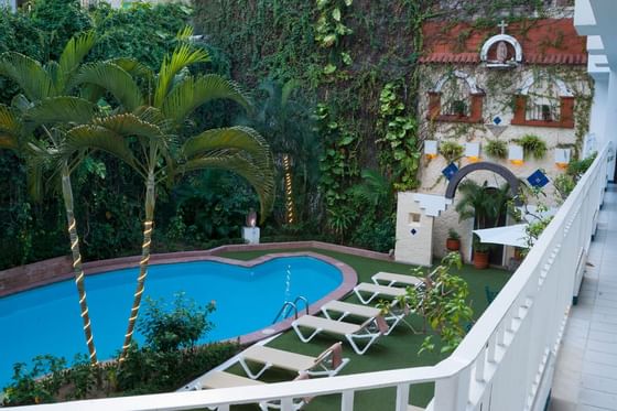 outdoor pool with garden and lounge chairs