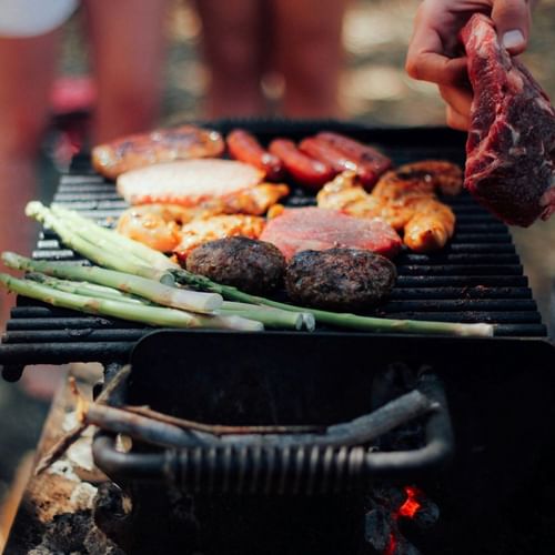 memorial day barbecue with burgers, sausages and chicken on a grill