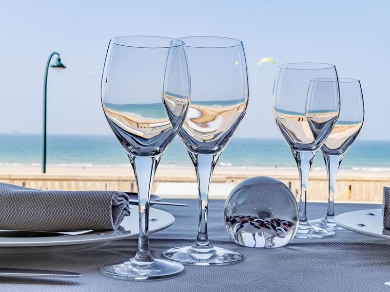 Wine glasses arranged on a dining table in Le Cap Horn at Le Grand Hôtel des Thermes
