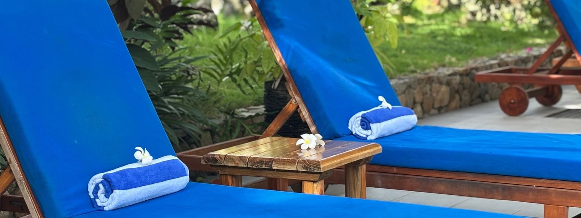 Blue cushioned loungers with a side table at Warwick Fiji Resort and Spa, Korolevu