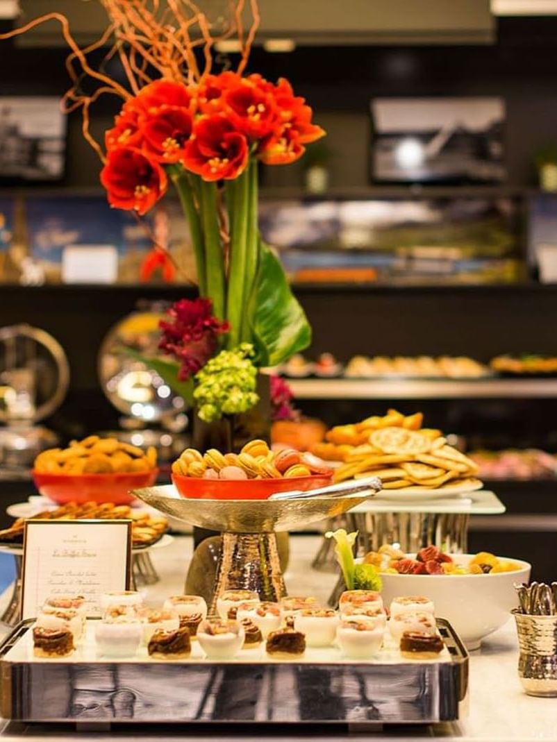 Floral centerpiece by tiered trays of pastries in Breakfast & 24-Hour Room Service at Warwick Paris Champs Elysées