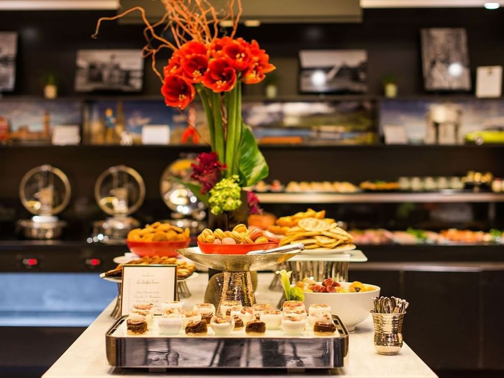 Floral centerpiece by tiered trays of pastries in Breakfast & 24-Hour Room Service at Warwick Paris Champs Elysées