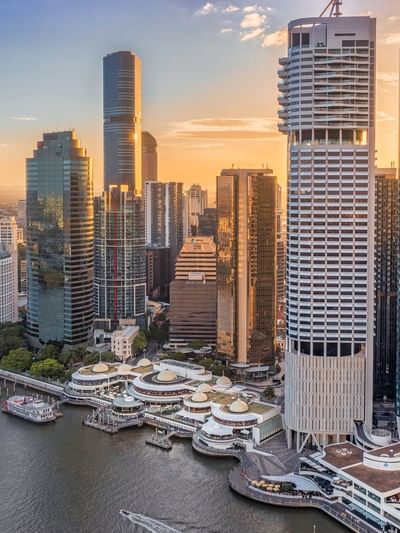 Aerial view of Eagle Street Pier with city skyline at sunset near Sofitel Brisbane Central