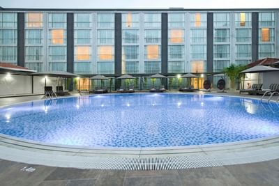 Outdoor swimming pool with pool beds at Eastin Grand Hotel Saigon