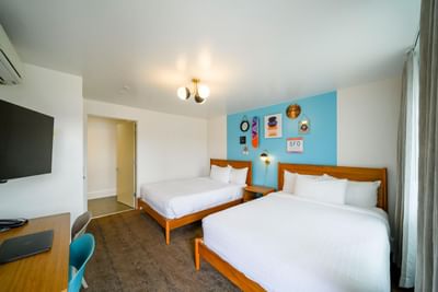 Double beds and nightstand with working area in Superior Two Queen Room at Becks Motor Lodge