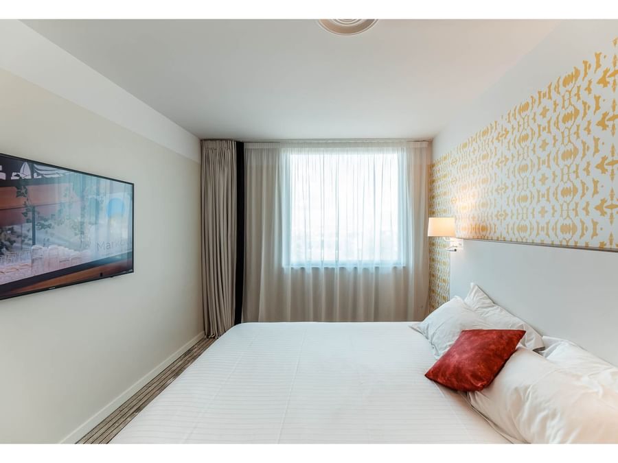 Double bed in suite bedroom at The Originals Hotels