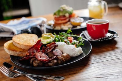 A table set with a breakfast plate alongside a coffee at Encore by Mingara