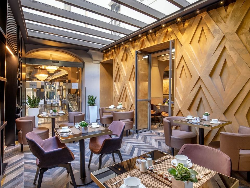 Interior of a Dining Room arranged for Breakfast with modern architecture and warm lighting at The Style