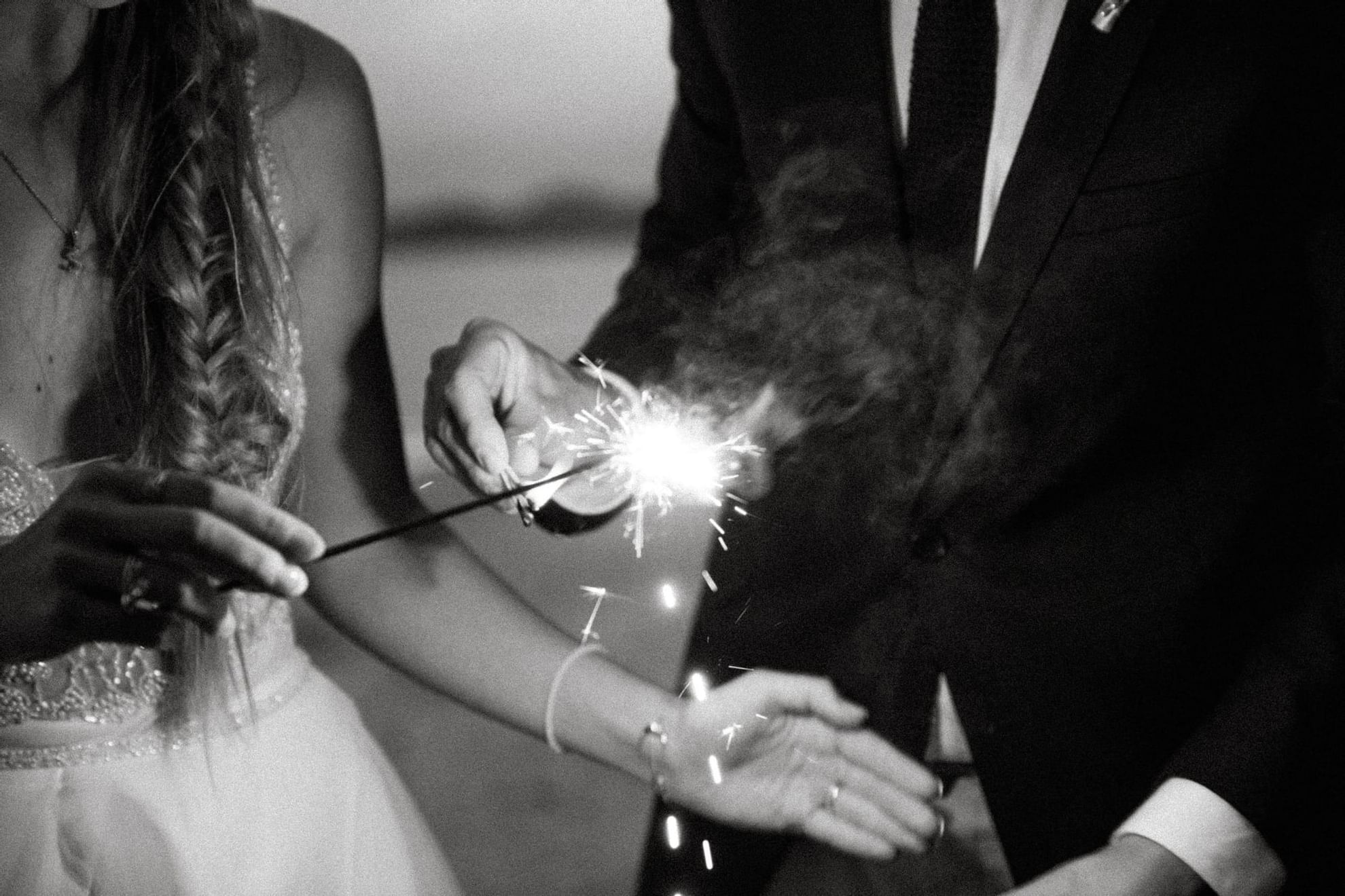 Couple holding sparklers, Pullman Palm Cove Sea Temple Resort
