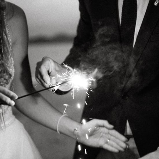Couple lighting sparklers at Pullman Palm Cove Sea Resort