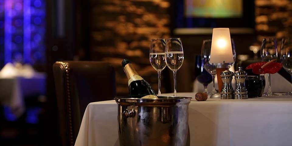 Dinner table with a champagne bottle in a silver bucket in Chandler's Steakhouse at Hotel 43 Boise