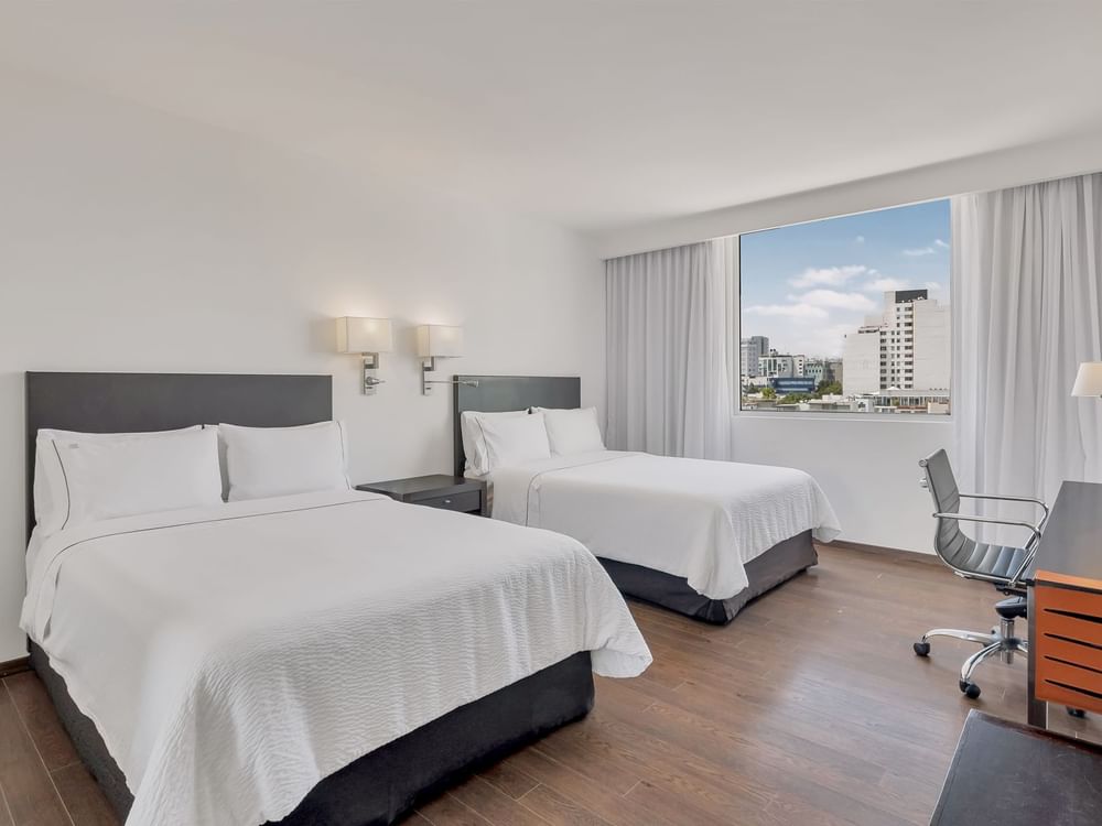 Work desk facing beds with city view in Superior Room, 2 Double at Fiesta Inn Insurgentes Sur