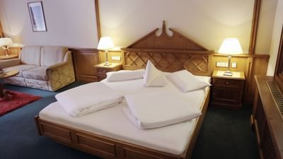Folded bedding on a bed in Premium Suite at Liebes Rot Flueh