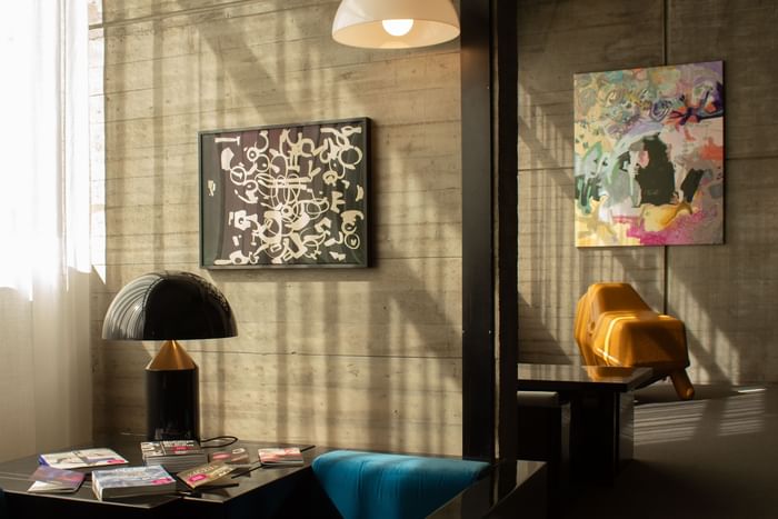 Modern room with abstract art, unique chairs, and a sleek table at DUPARC Contemporary Suites