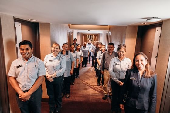 Hotel staff posing in a hallway at Araiza Mexicali
