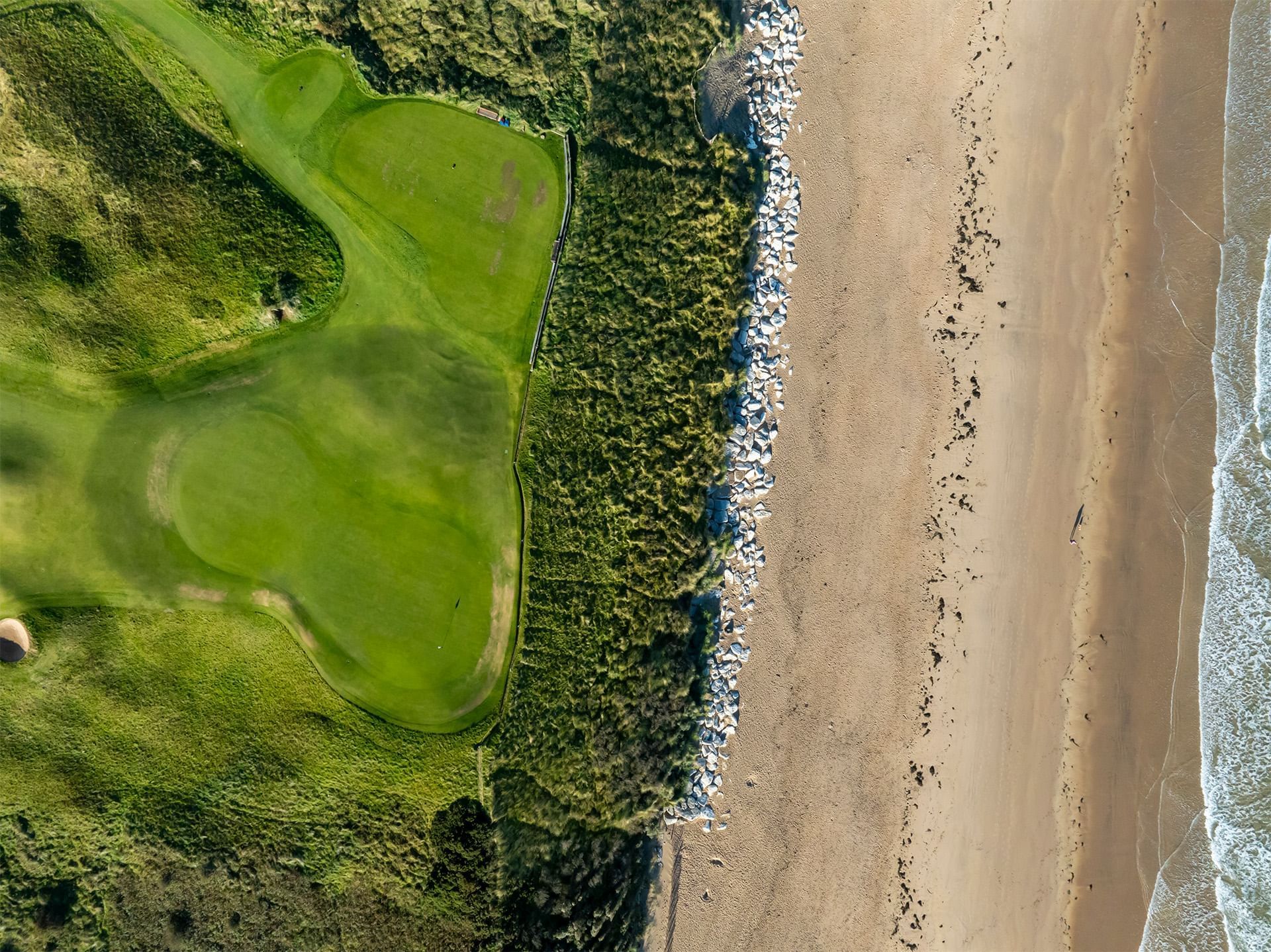 Aerial view of Royal Portrush golf club with ocean near Dunluce Lodge